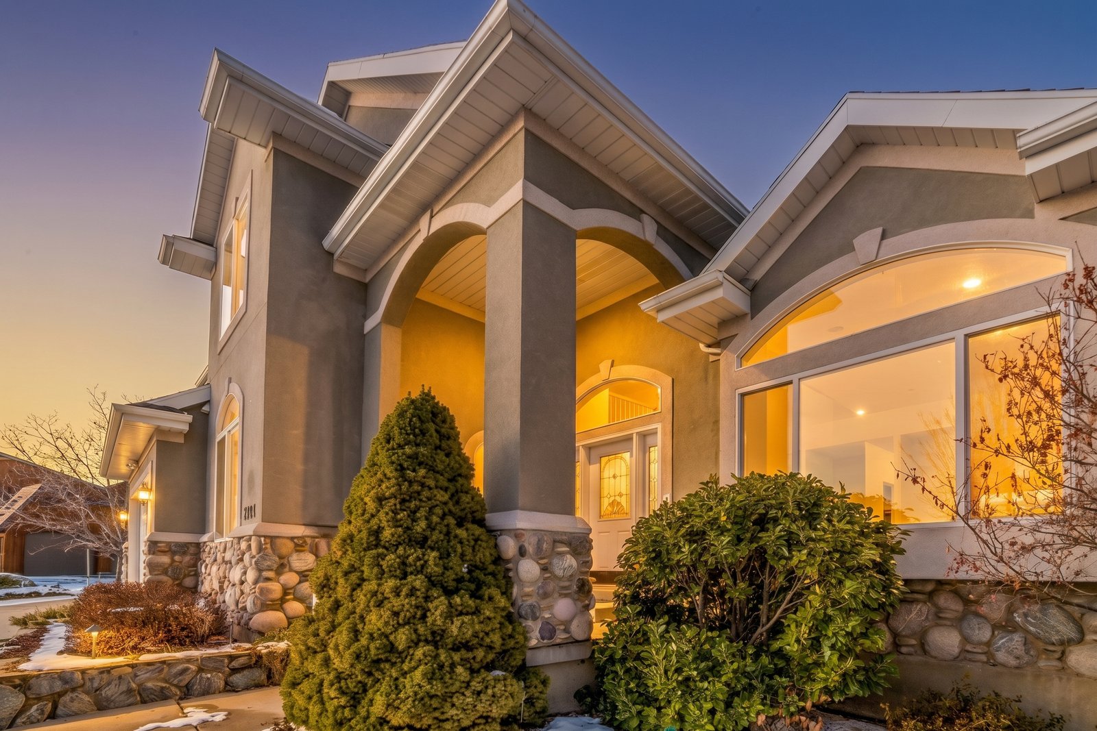 Same home edited to a warm dusk twilight scene